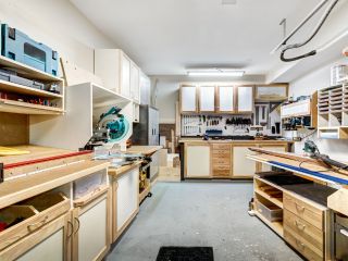 Custom Garage Workshop with Built-In Storage – Mound, MN Spacious garage workshop in Mound, MN, featuring built-in cabinets, organized tool storage, wood workbenches, and overhead lighting for a clean, functional workspace.